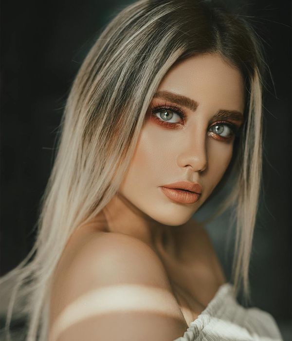 Young woman looking into the distance with a fresh and calm expression.